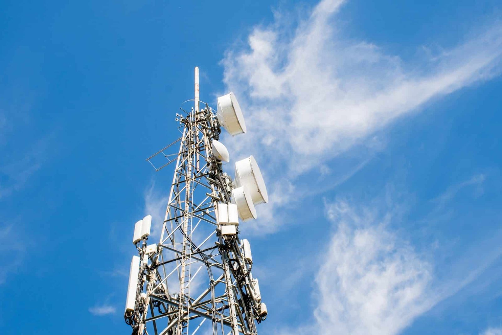 radio communication and cell tower on blue sky background